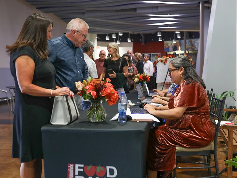 Event guests check in at a registration table.